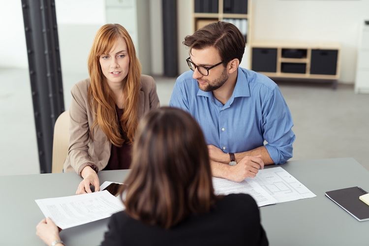 couple signing a prenuptial agreement